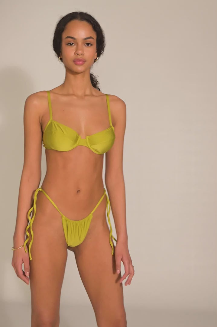 BIKINI DOLLS Gigi minimal bikini bottom with adjustable coverage and side ties in Peridot video