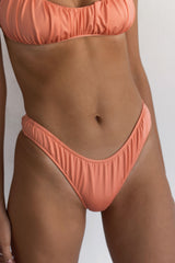 BIKINI DOLLS Arielle ruched bikini bottom in Peach Pink