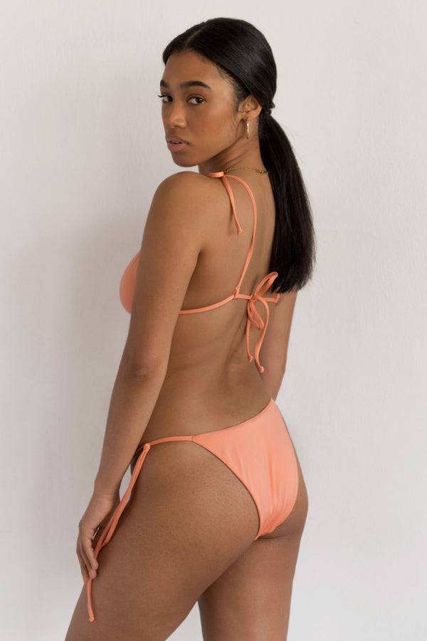 BIKINI DOLLS Gia side tie high-cut bikini bottom in Peach Pink